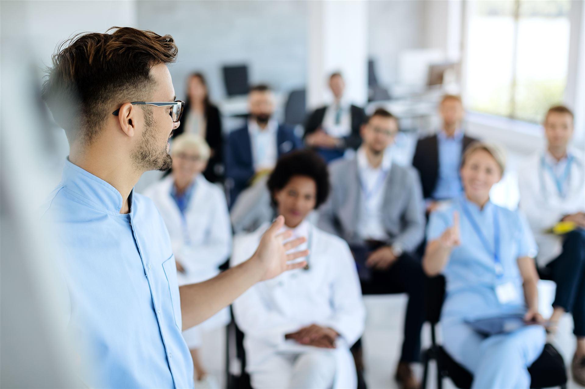 Deelnemers meeting luisteren aandachtig naar docent